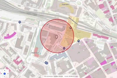 Kaart met een rode en gele cirkel, gebieden en wegen in een stedelijke omgeving.